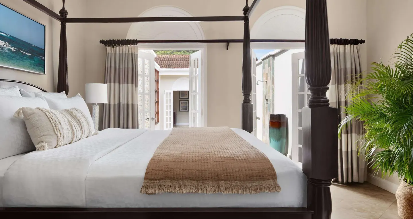 Four-poster king bed in the Honeymoon Villa bedroom at Sandals Ochi.