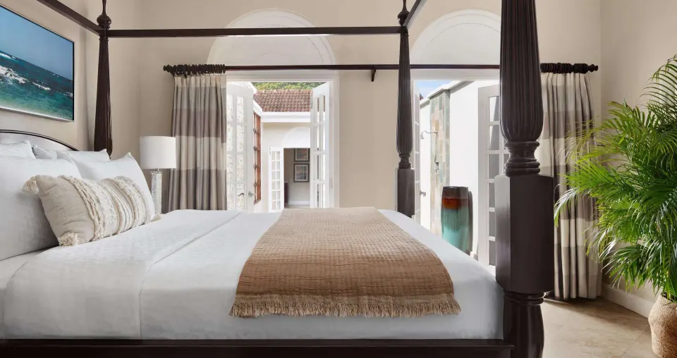Four-poster king bed in the Honeymoon Villa bedroom at Sandals Ochi.