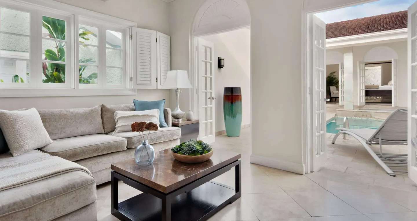 Living room sofa opening to the private pool courtyard at Sandals Ochi.