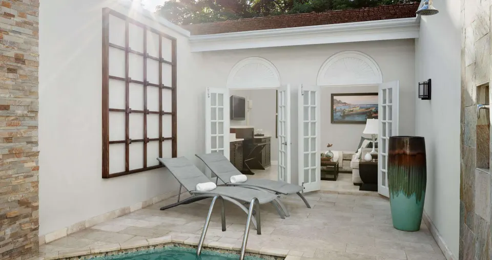 Private pool courtyard with lounge chairs outside the Honeymoon Villa at Sandals Ochi.