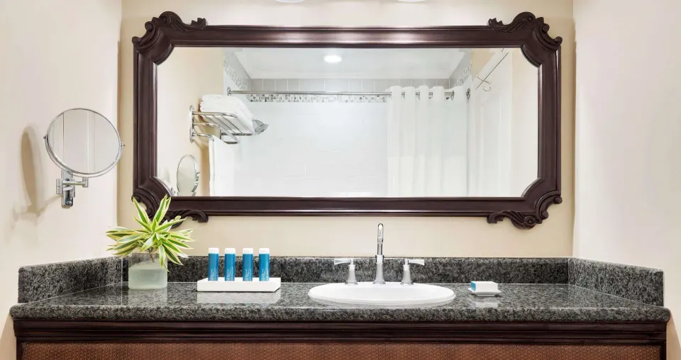 Luxury Room bathroom vanity with large mirror at Sandals Ochi.
