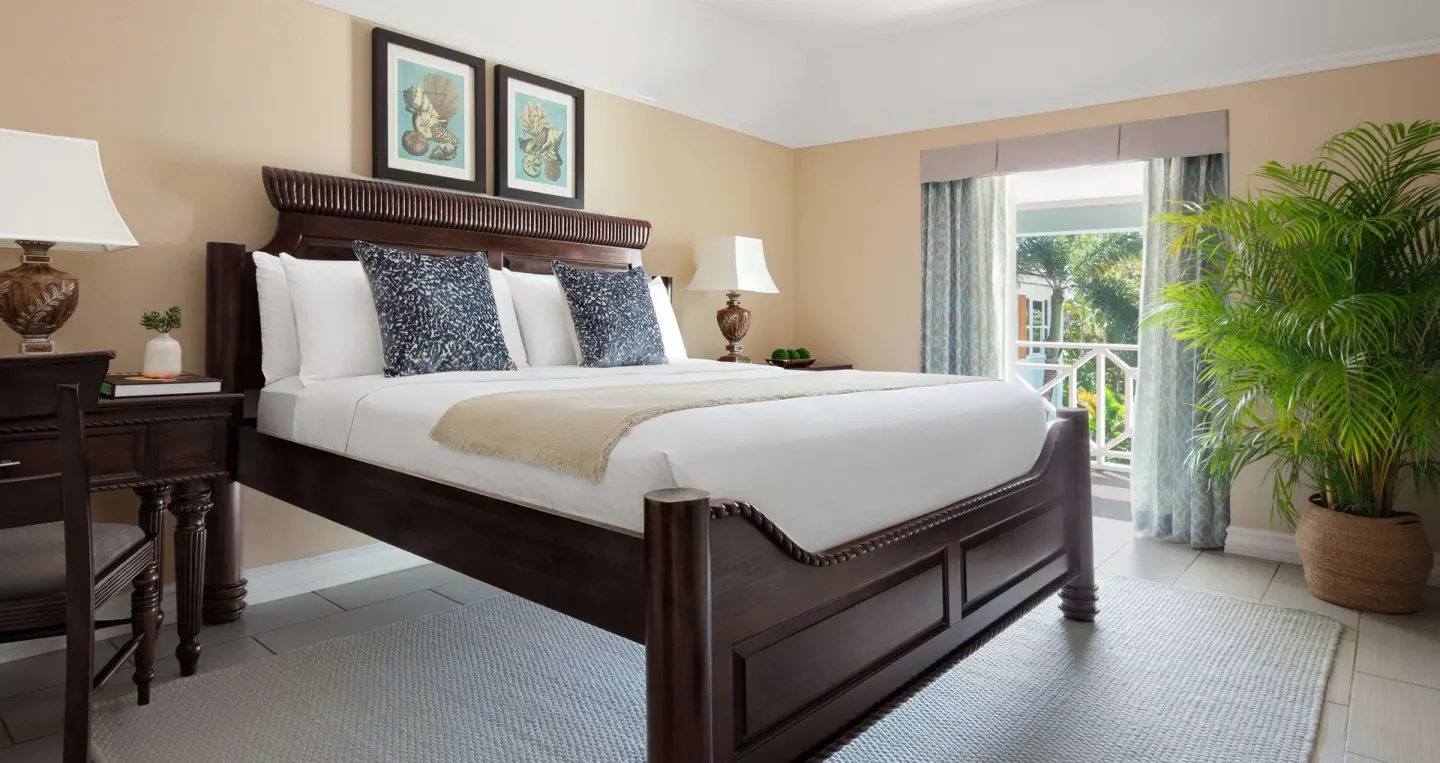 Luxury Room king bed and balcony garden view at Sandals Ochi.