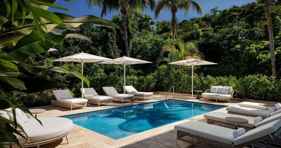 Garden pool with loungers and umbrellas at Sandals Ochi.