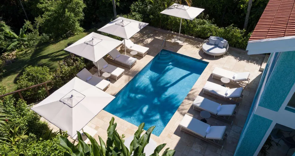 Overhead view of a villa pool deck with umbrellas at Sandals Ochi.