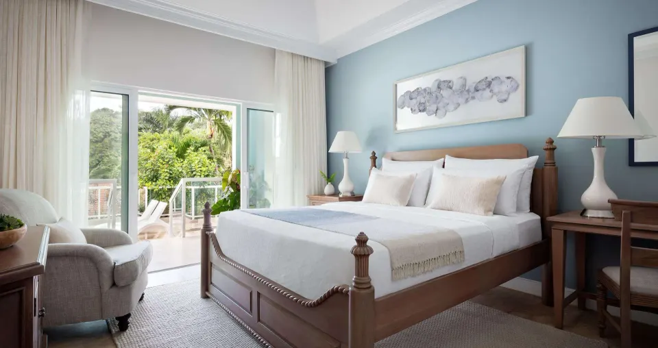 Poolside butler estate suite bedroom with balcony at Sandals Ochi.
