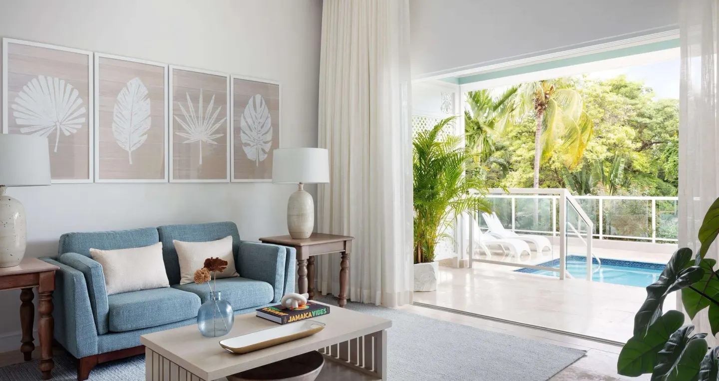 Poolside butler estate suite living room with private pool terrace at Sandals Ochi.