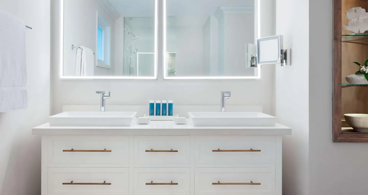 Double vanity bathroom in a villa poolside Club Level room at Sandals Ochi.