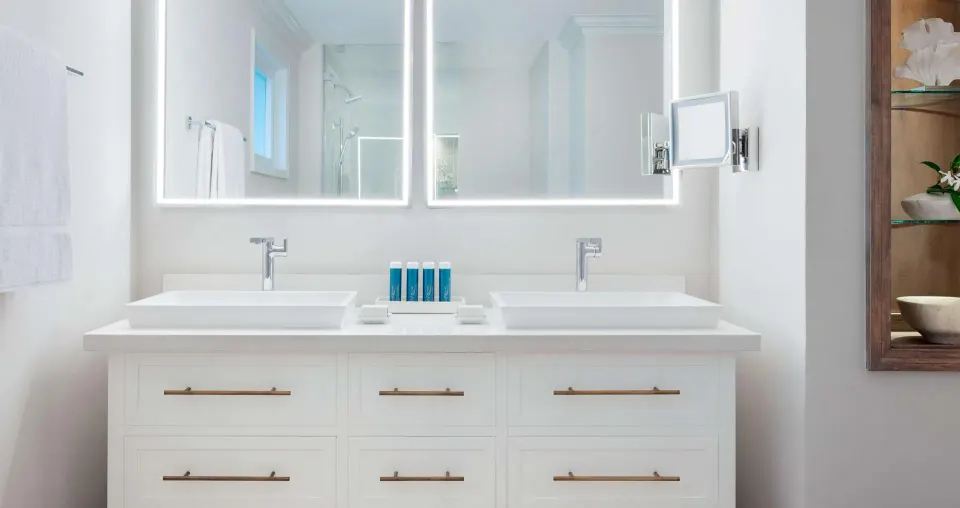 Double vanity bathroom in a villa poolside Club Level room at Sandals Ochi.