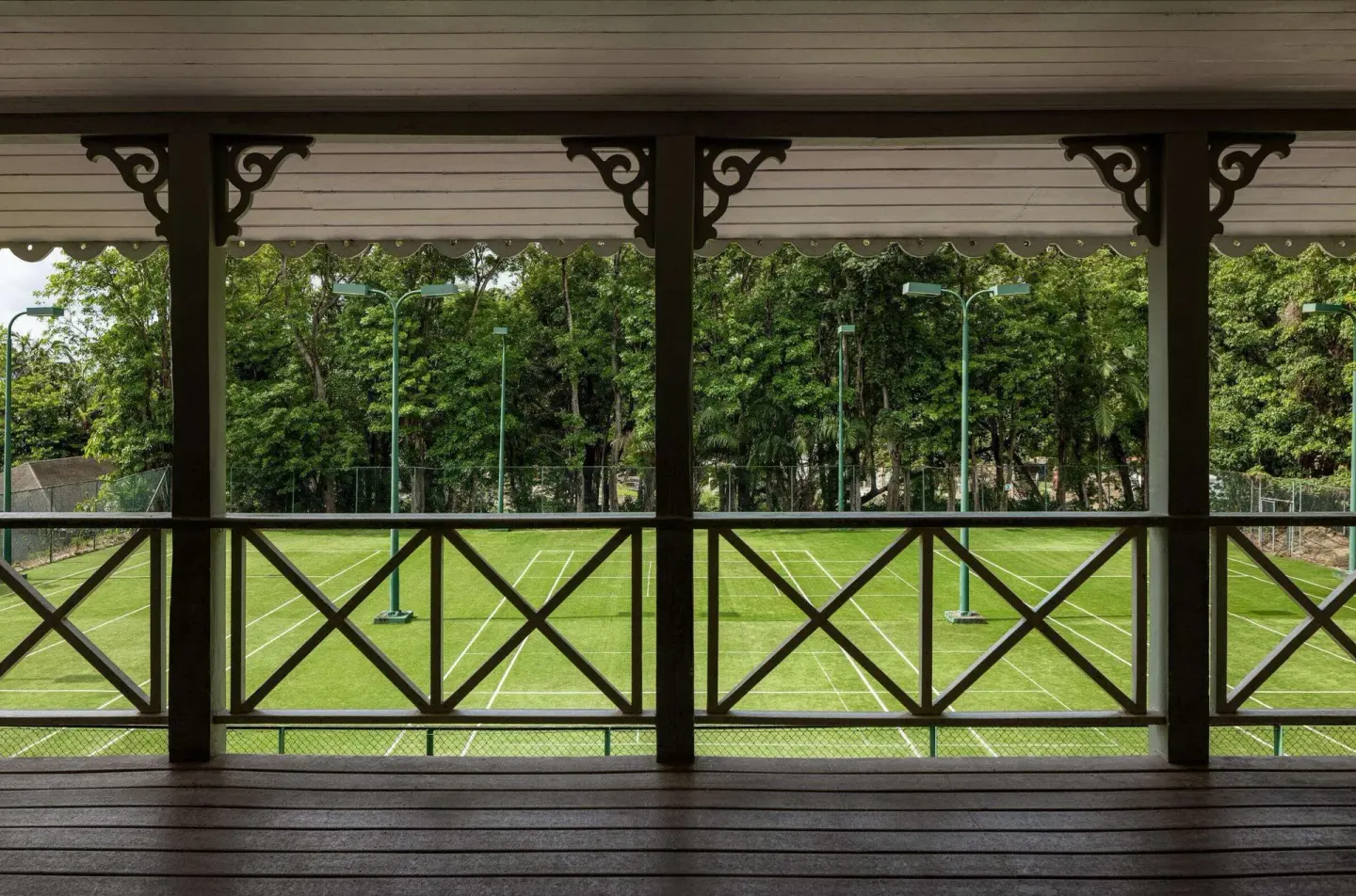 A covered veranda overlooks tennis courts at Sandals Regency La Toc.