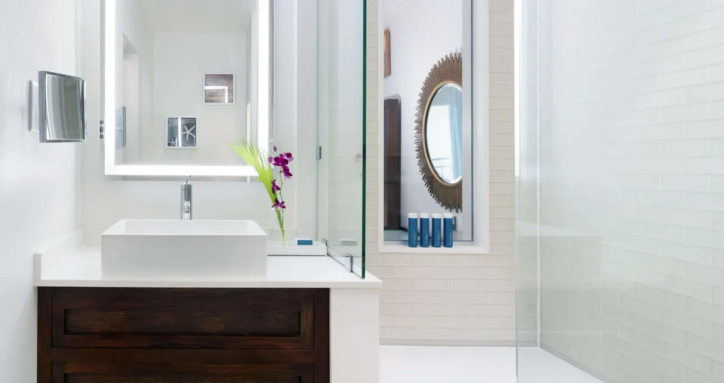 Guest bathroom vanity and glass shower at Sandals Regency La Toc.