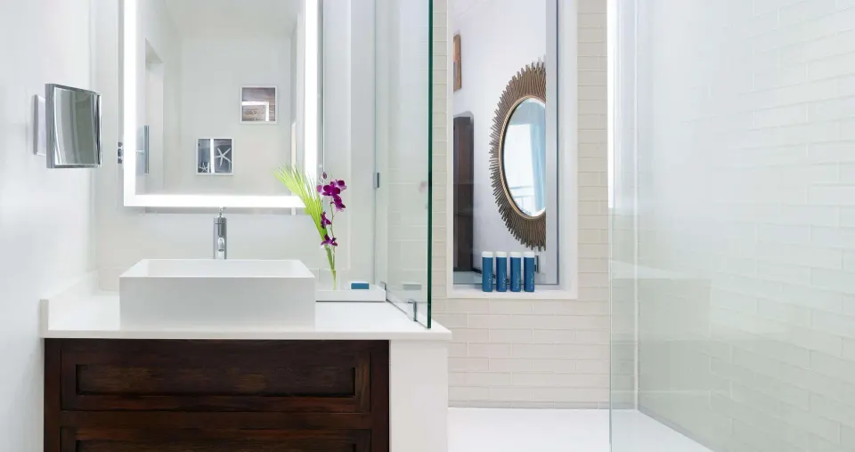Guest bathroom vanity and glass shower at Sandals Regency La Toc.
