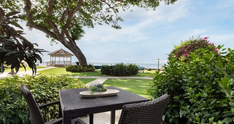 Walkout patio with garden and ocean view at Sandals Regency La Toc.