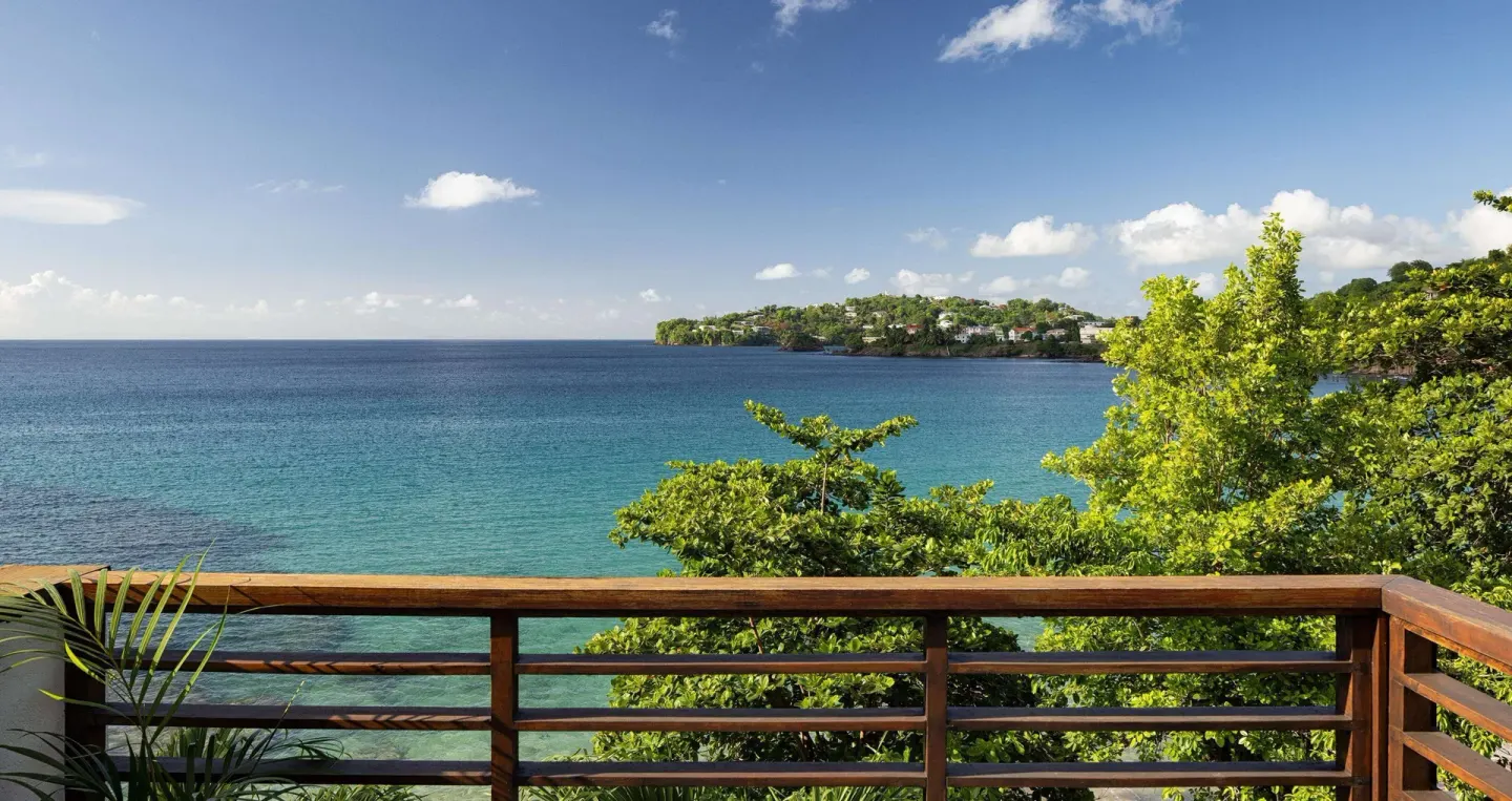 Balcony railing overlooking blue ocean from Sandals Regency La Toc.
