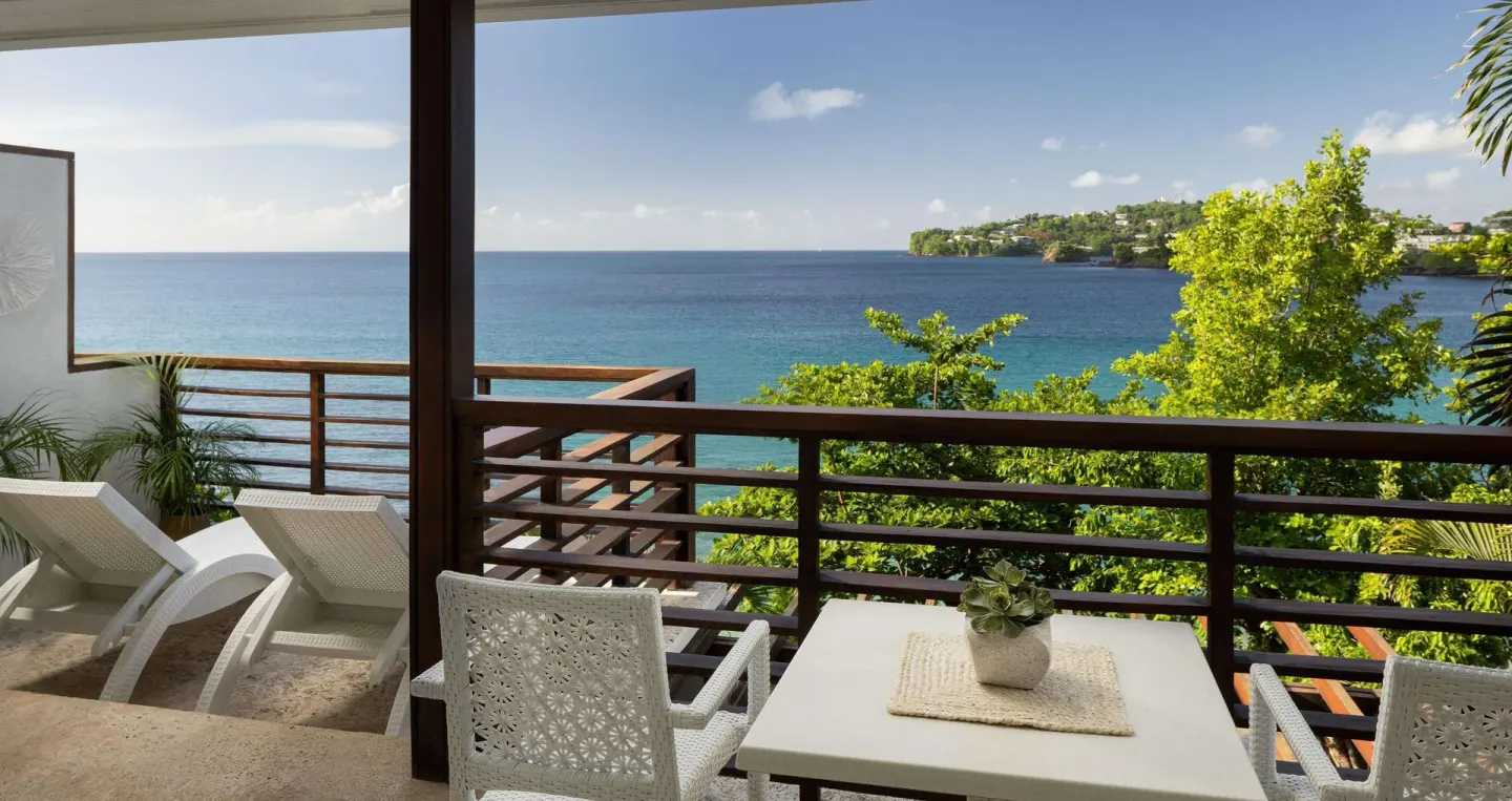 Furnished ocean-view balcony for a villa suite at Sandals Regency La Toc.