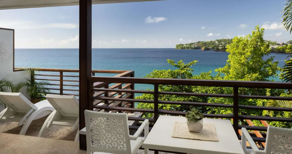 Furnished ocean-view balcony for a villa suite at Sandals Regency La Toc.