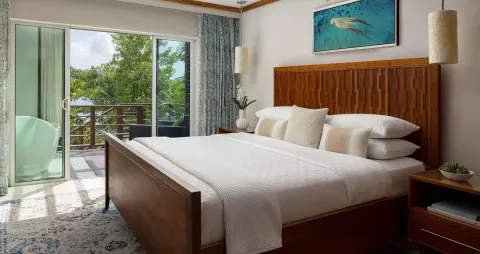 King bed in an ocean-view villa bedroom at Sandals Regency La Toc.