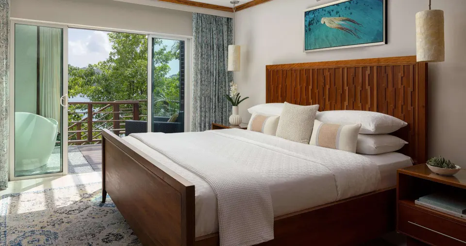 King bed in an ocean-view villa bedroom at Sandals Regency La Toc.