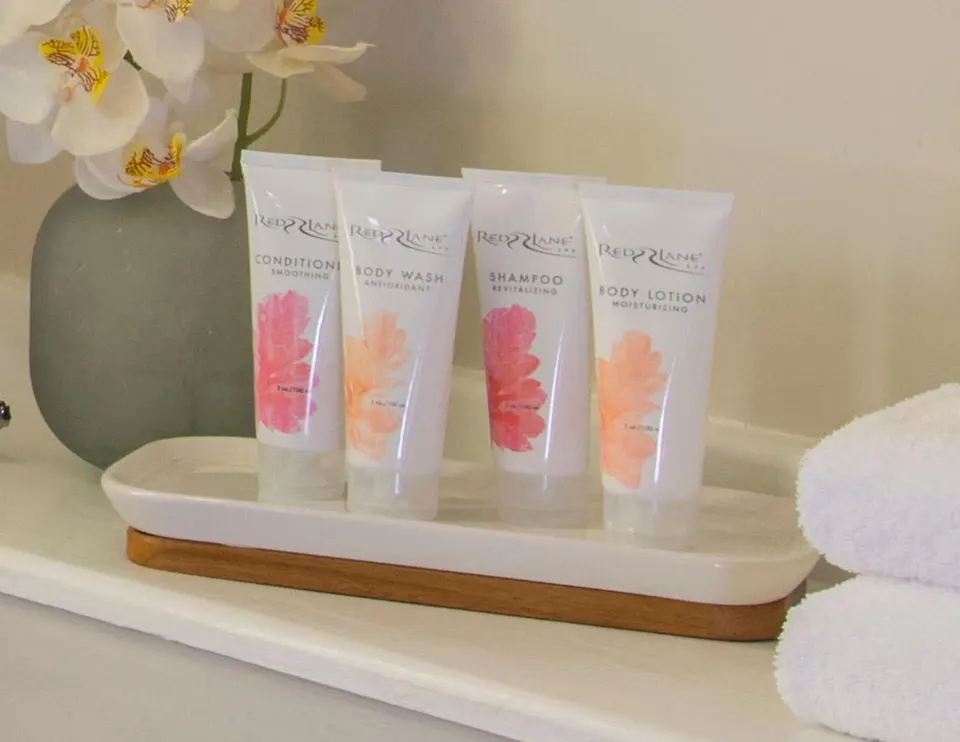 Bathroom amenities, towels and flowers in a guest room at Sandals Regency La Toc.