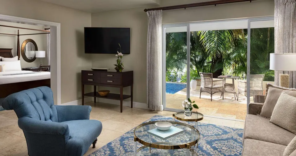 Honeymoon suite living room with patio and pool view at Sandals Regency La Toc.