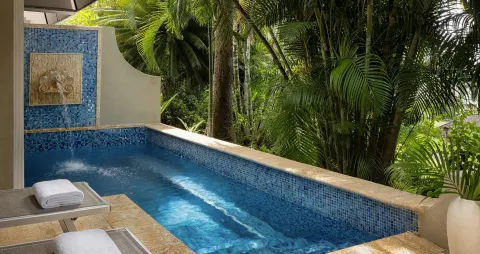Private blue-tiled pool with tropical garden views at Sandals Regency La Toc.