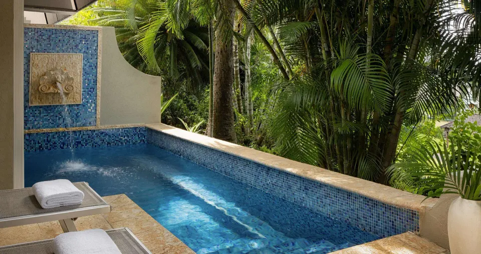 Private blue-tiled pool with tropical garden views at Sandals Regency La Toc.