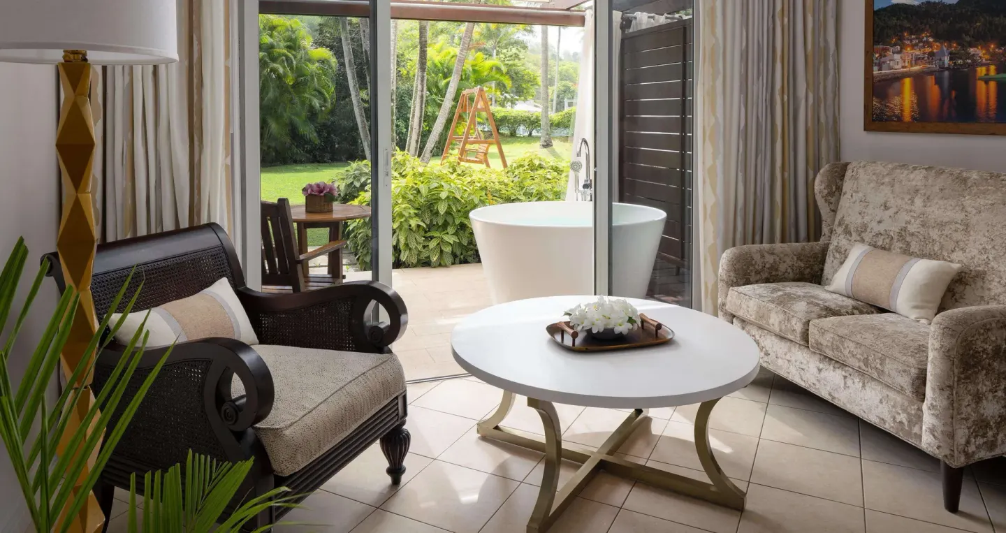 Honeymoon suite sitting area and patio soaking tub at Sandals Regency La Toc.
