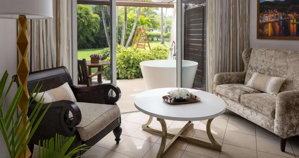 Honeymoon suite sitting area and patio soaking tub at Sandals Regency La Toc.