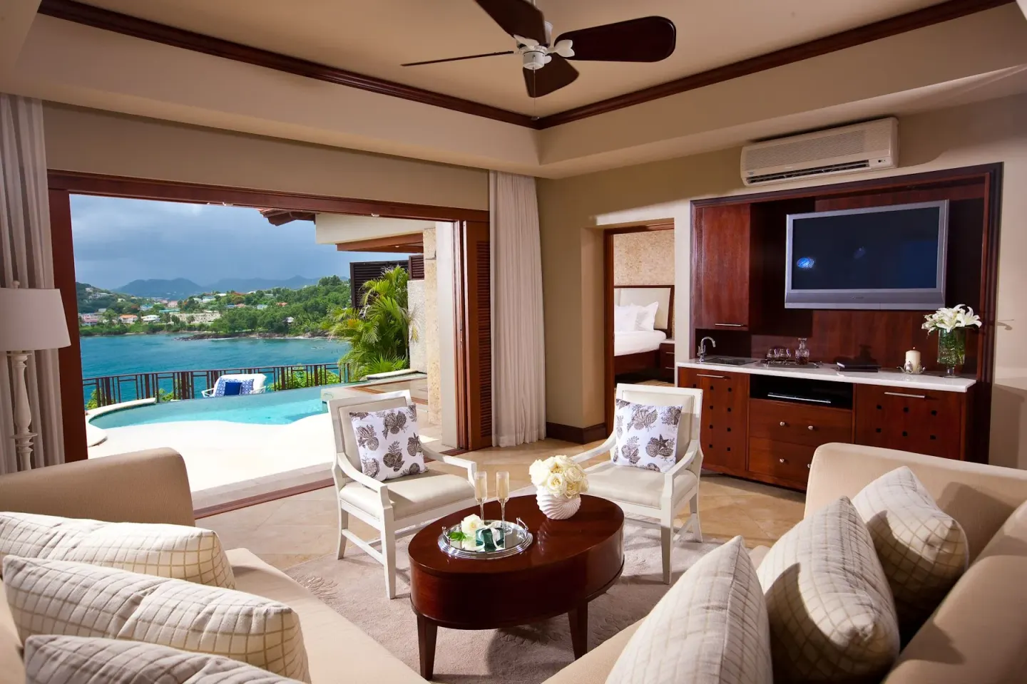 Luxury poolside suite living area with ocean view at Sandals Regency La Toc.