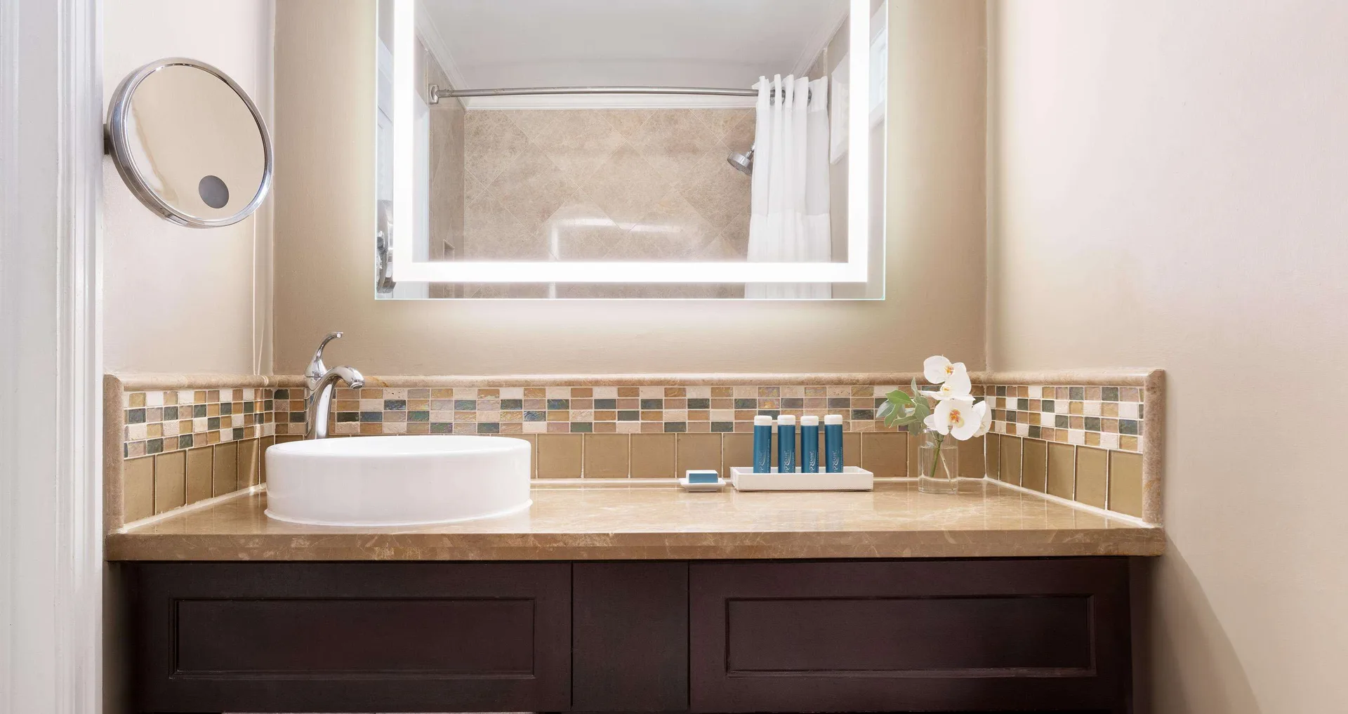 Bathroom vanity with vessel sink and mirror at Sandals Regency La Toc.