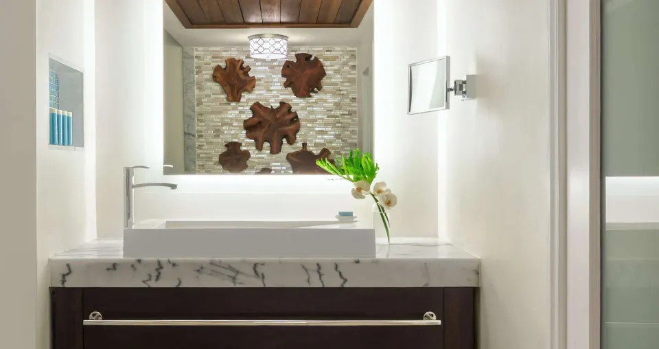 Bathroom vanity with marble counter in a luxury suite at Sandals Regency La Toc.