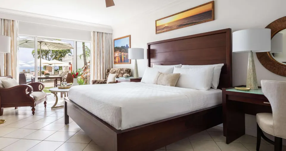 Emerald Oceanview Walkout bedroom with king bed and patio at Sandals Regency La Toc.