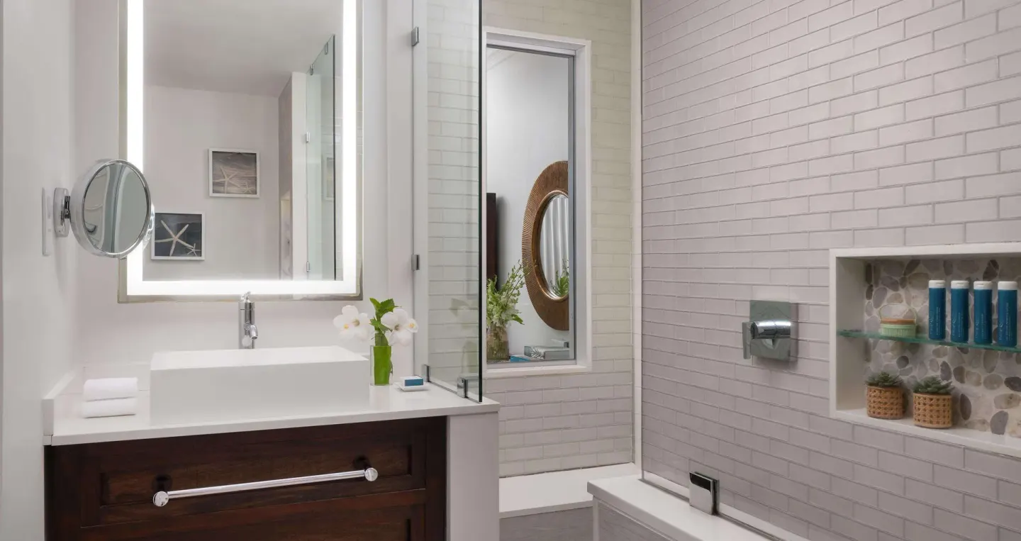 Bathroom vanity and tub in an Emerald Oceanfront room at Sandals Regency La Toc.