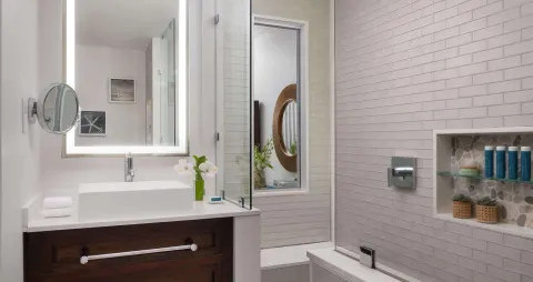 Bathroom vanity and tub in an Emerald Oceanfront room at Sandals Regency La Toc.