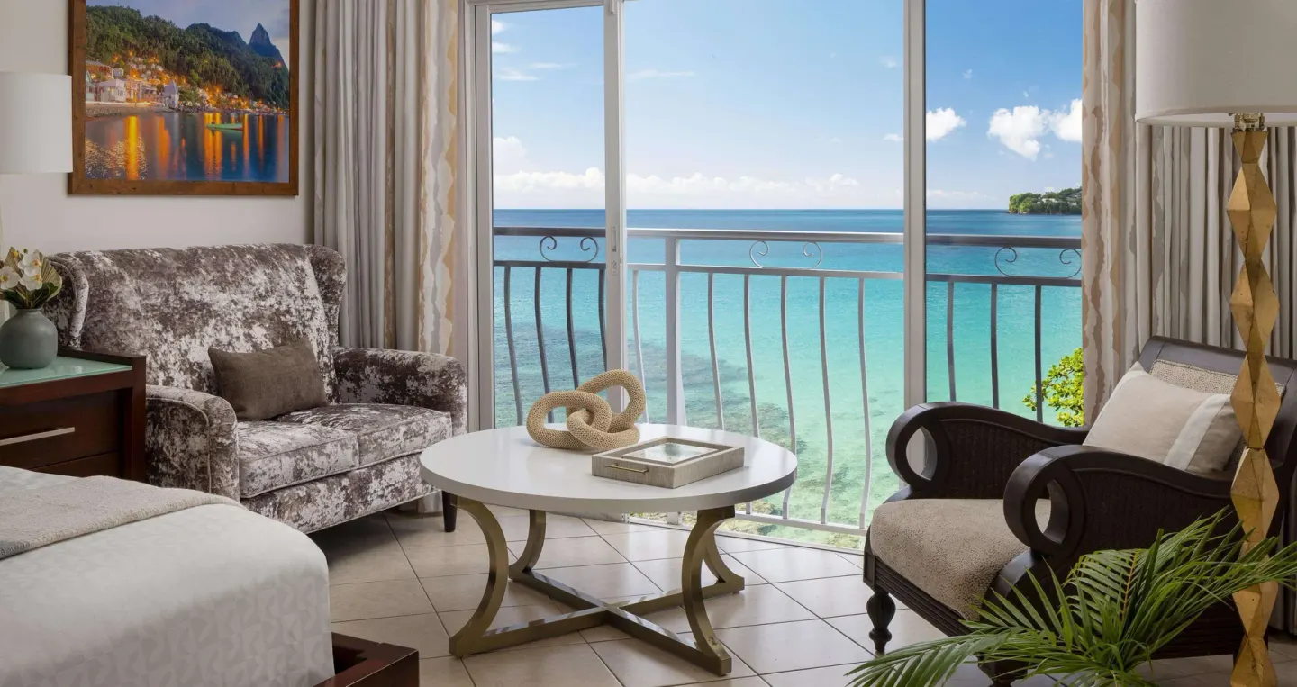Ocean-view sitting area in an Emerald Oceanfront room at Sandals Regency La Toc.