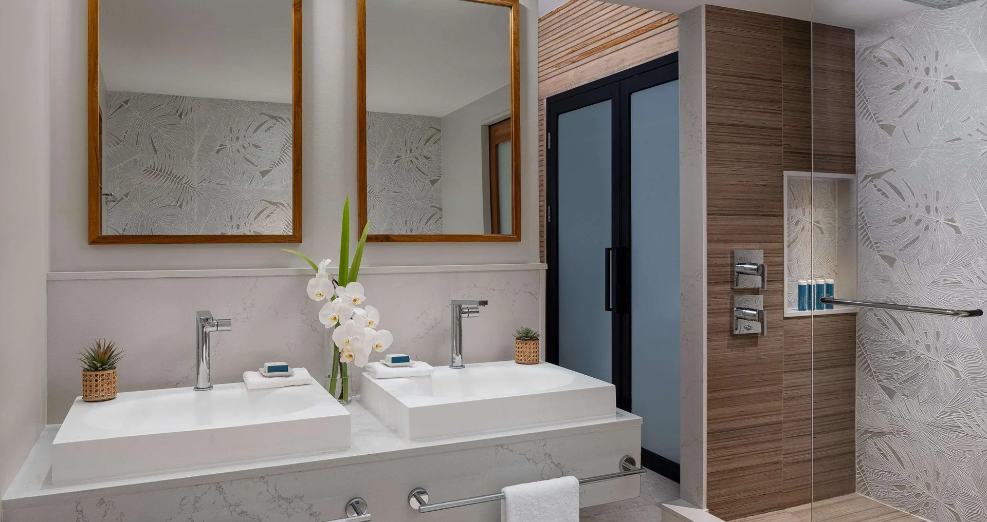 Double vanity and glass shower in a villa bathroom at Sandals Regency La Toc.