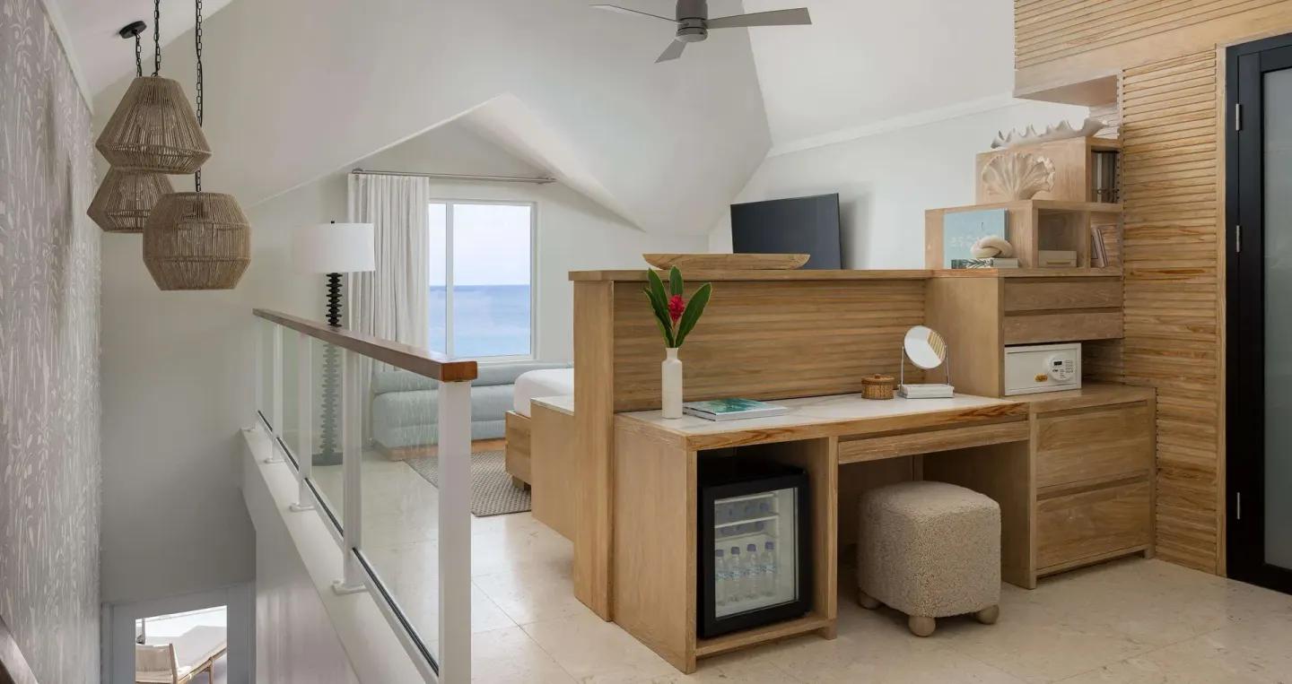 Upper-level villa bedroom area with ocean view at Sandals Regency La Toc.