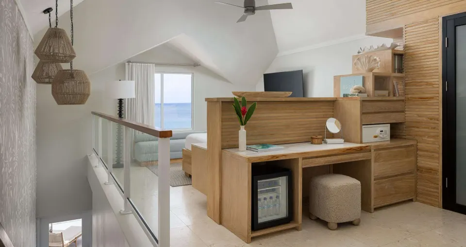 Upper-level villa bedroom area with ocean view at Sandals Regency La Toc.