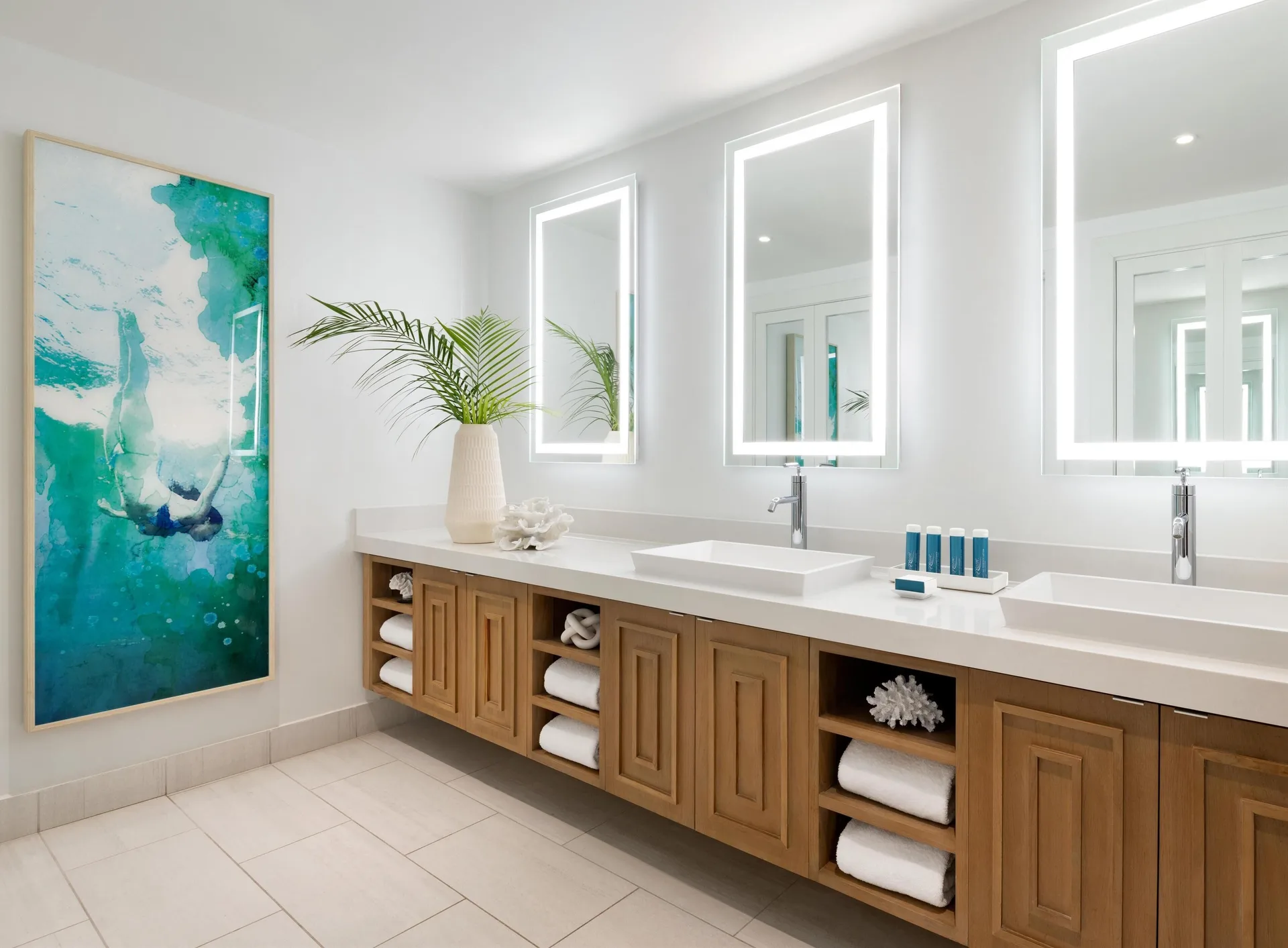 Double-sink bathroom vanity with lighted mirrors at Sandals Royal Bahamian.