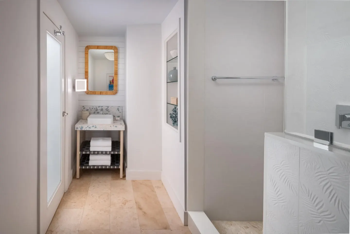 Guest bathroom with vanity alcove and walk-in shower at Sandals Royal Bahamian.