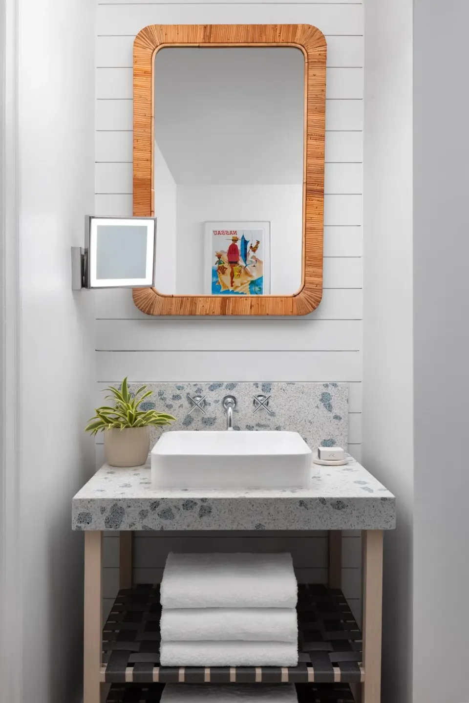 Guest bathroom vanity with vessel sink and rattan mirror at Sandals Royal Bahamian.