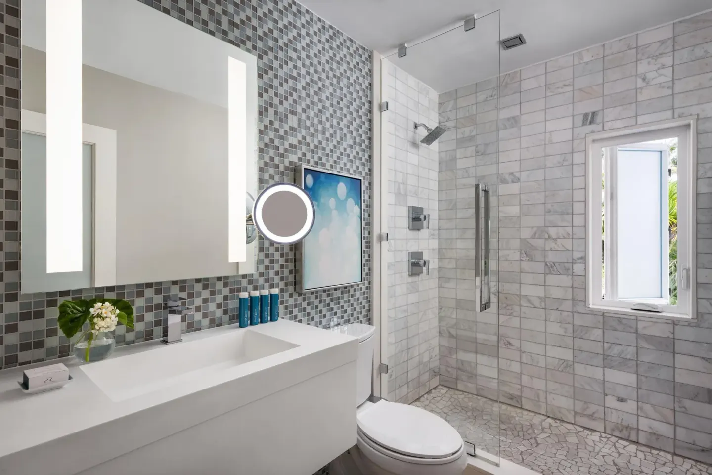 Modern bathroom with glass shower and mosaic tile at Sandals Royal Bahamian.