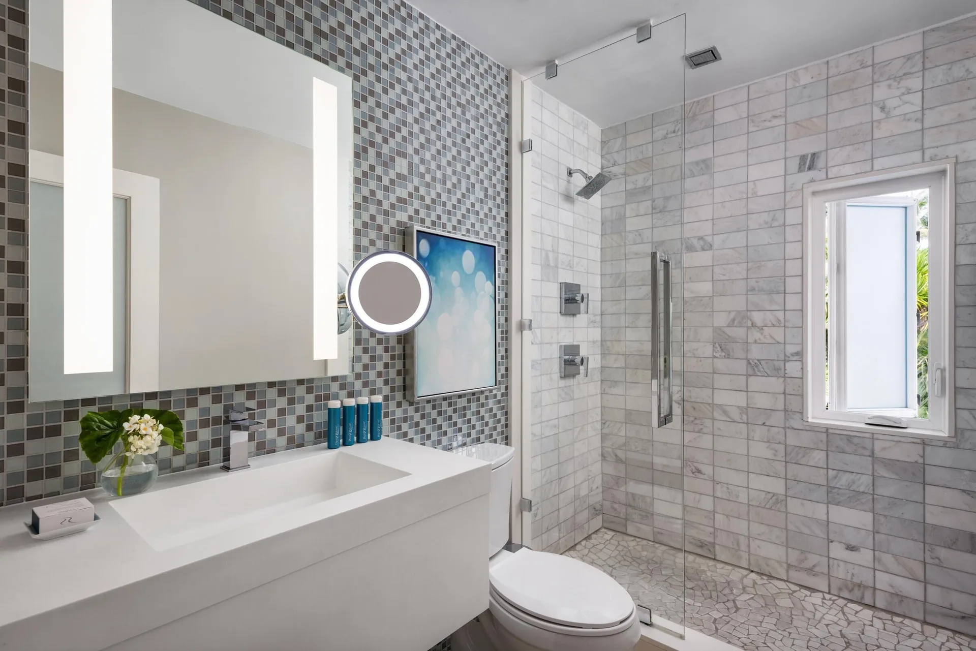 Modern bathroom with glass shower and mosaic tile at Sandals Royal Bahamian.