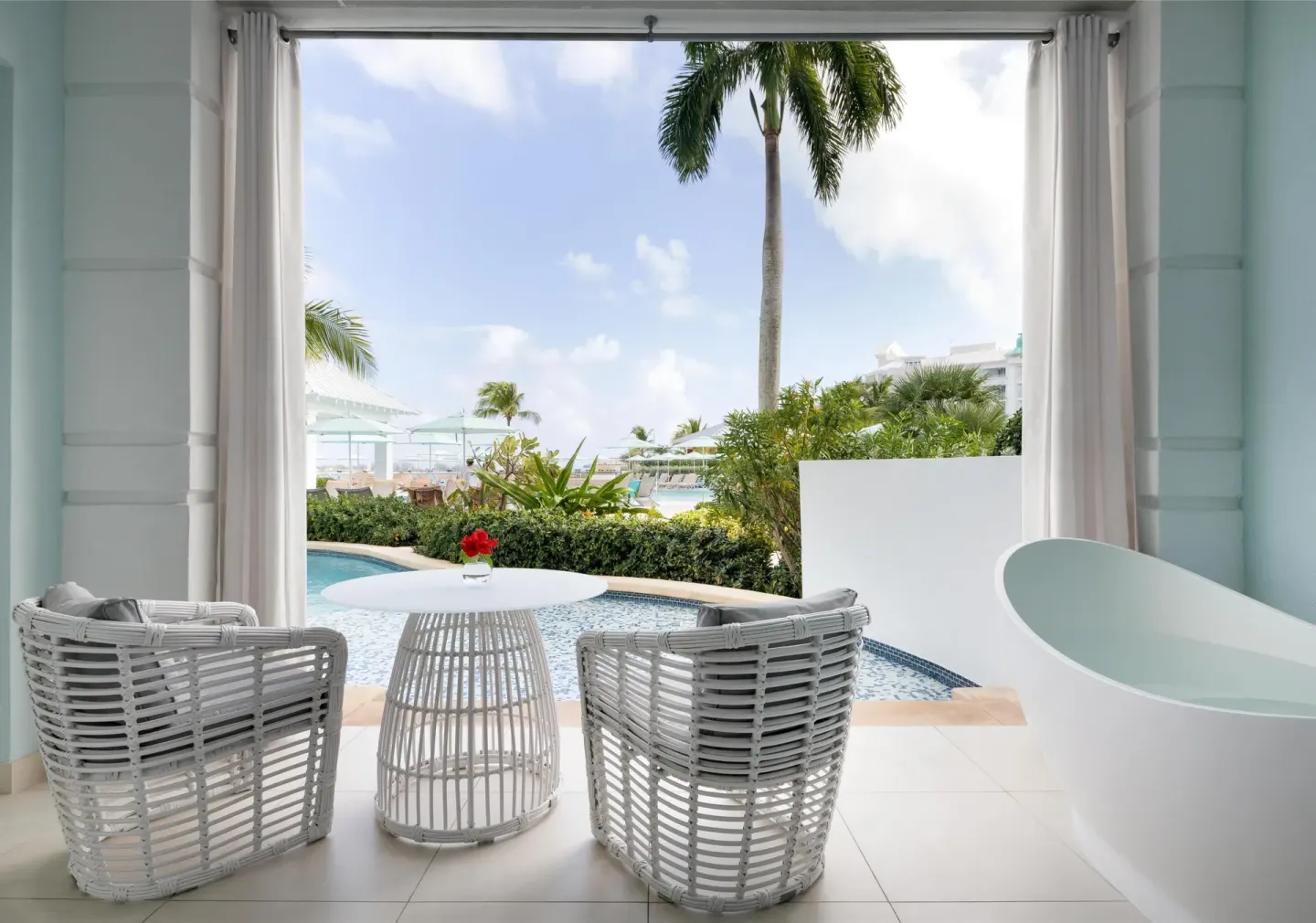 Private patio with soaking tub and pool view at Sandals Royal Bahamian.