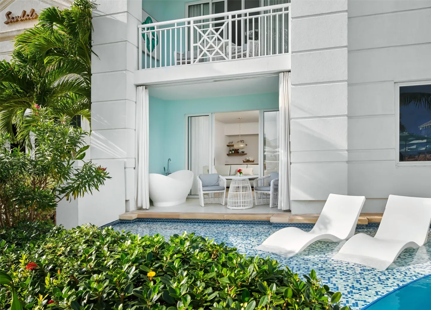 Swim-up suite patio with soaking tub and pool loungers at Sandals Royal Bahamian.