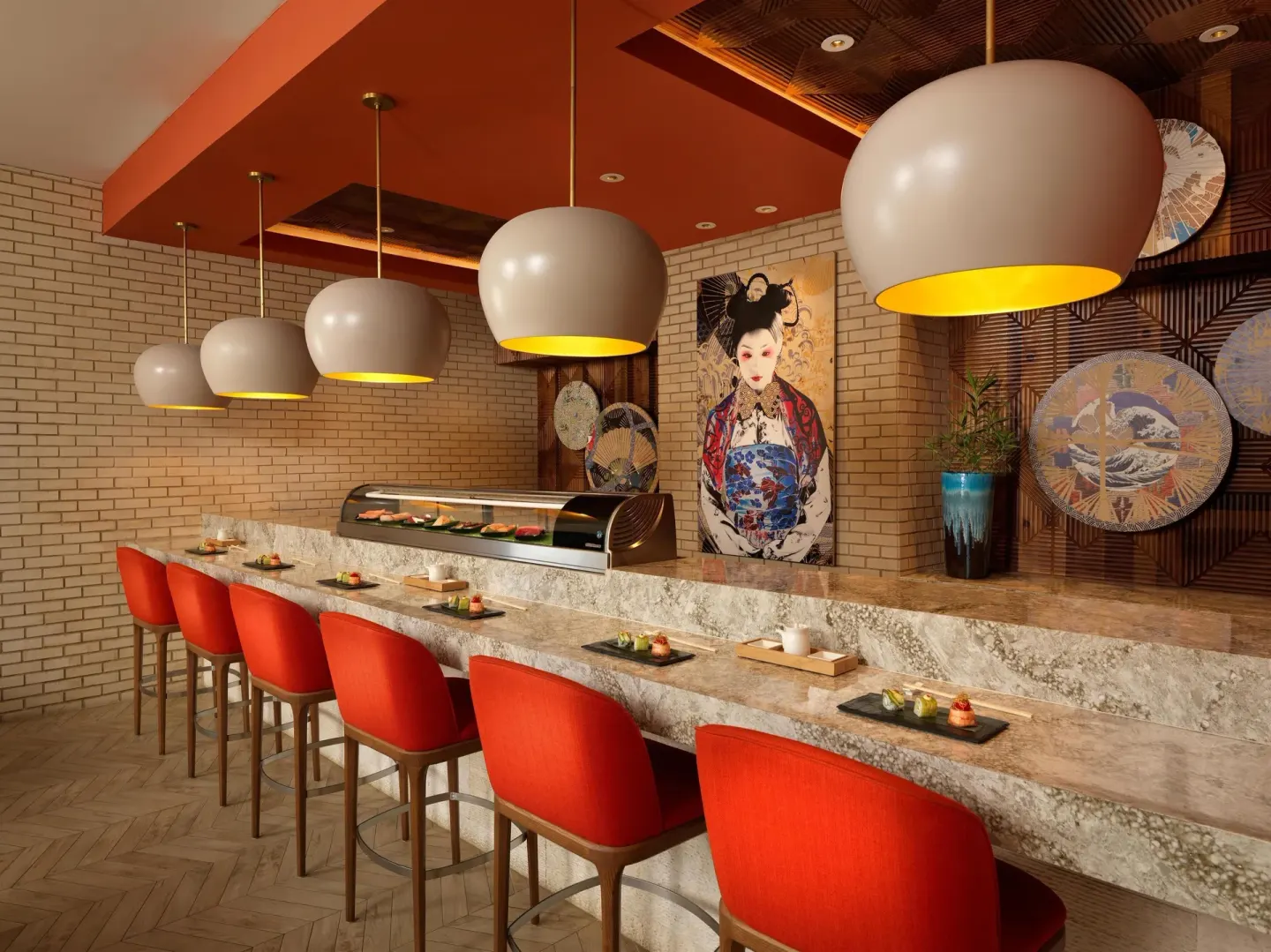 Sushi bar with red stools and Japanese-inspired artwork at Sandals Royal Bahamian.