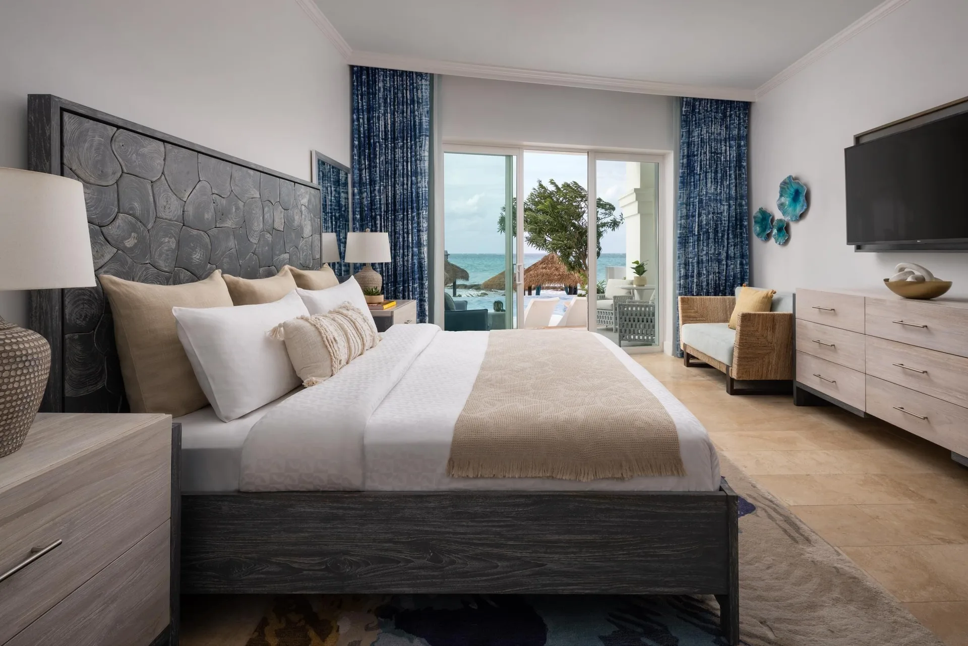 East Bay Beachfront Swim-up Butler Suite bedroom with king bed at Sandals Royal Bahamian.