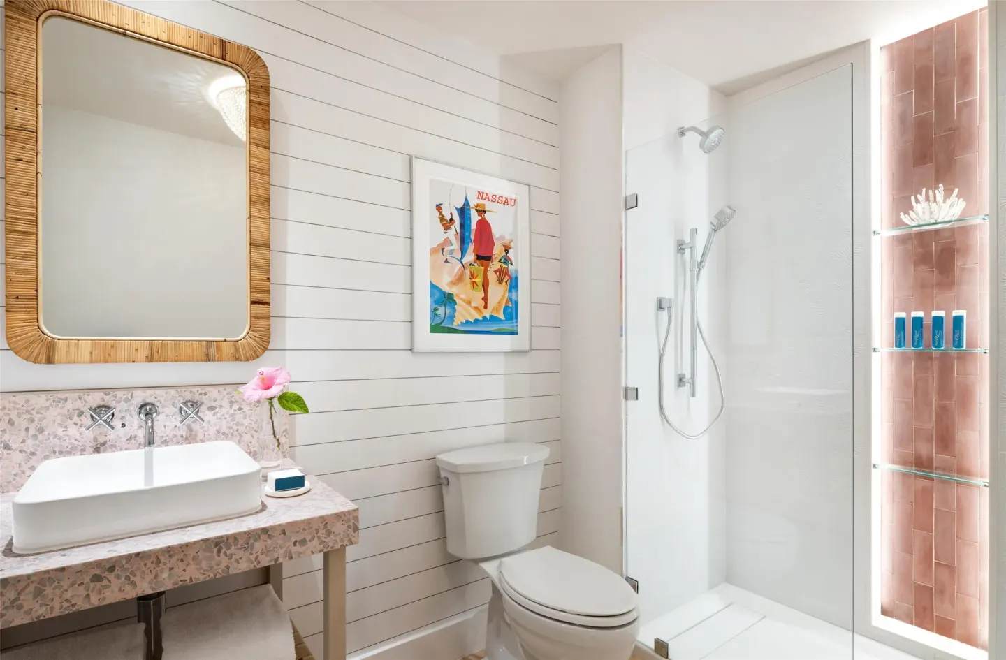 Bathroom with vanity, toilet, and glass shower in a suite at Sandals Royal Bahamian.