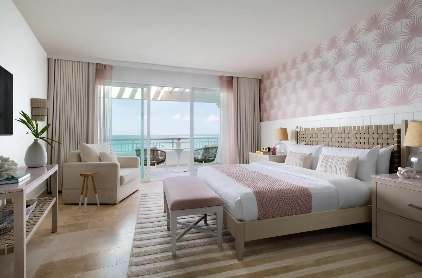 East Bay Honeymoon Beachfront Butler Suite king bed and balcony at Sandals Royal Bahamian.