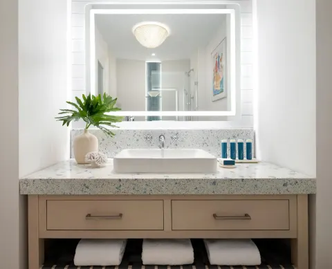 East Bay Oceanview Premium bathroom vanity with lit mirror at Sandals Royal Bahamian.