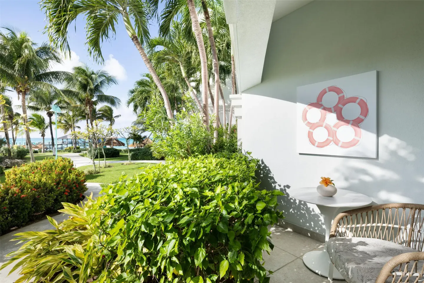Patio outside an East Bay Poolside Walkout Club Level Room at Sandals Royal Bahamian.